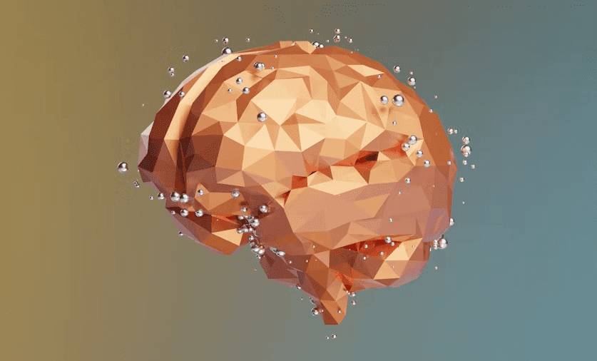 A low-poly illustration of a human brain surrounded by small floating spheres.
